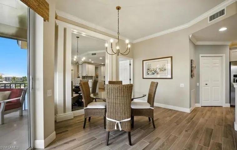 Dining space featuring wood finish floors, crown molding, a chandelier, and recessed lighting