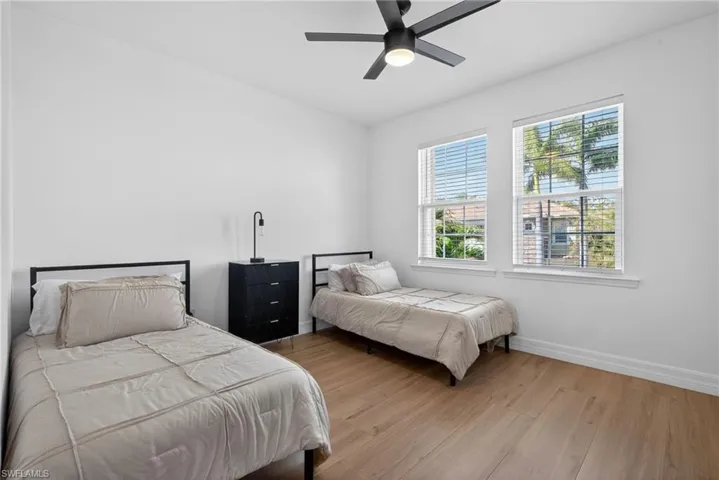 Bedroom with wood finished floors and a ceiling fan