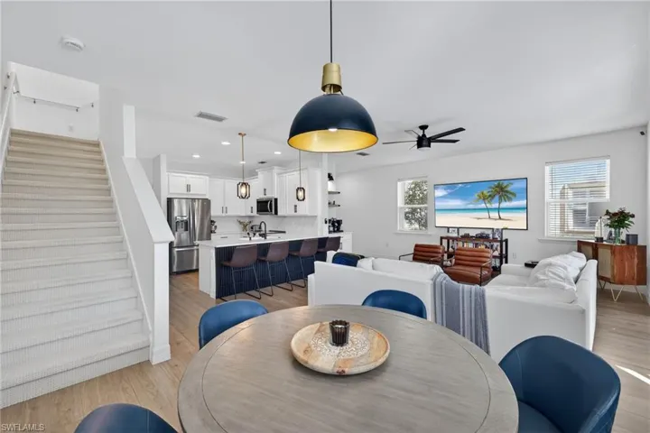 Dining space with light wood-style flooring, recessed lighting, and ceiling fan