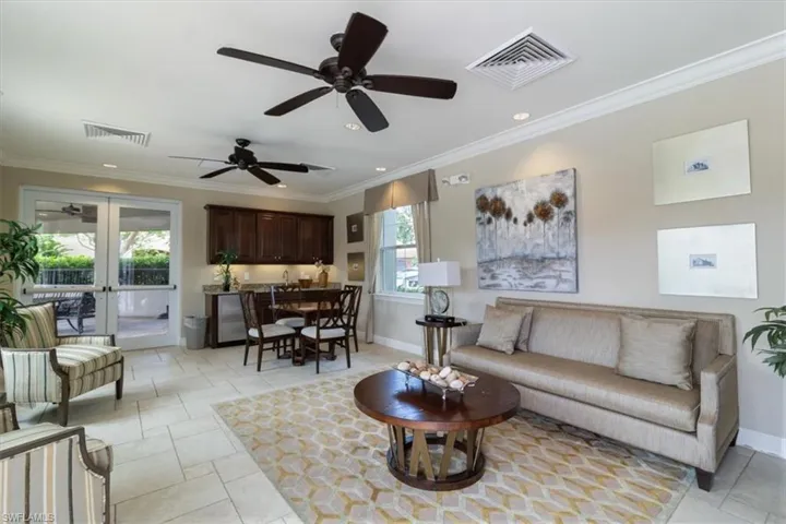 Living room featuring crown molding, a ceiling fan, french doors, recessed lighting, and light tile patterned floors