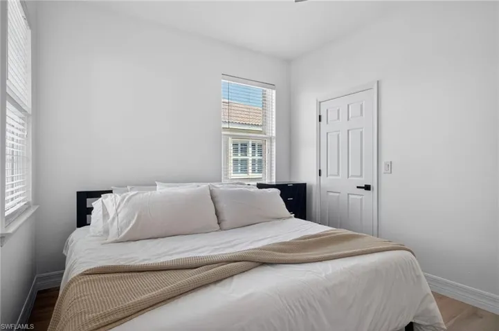 Bedroom with baseboards and wood finished floors
