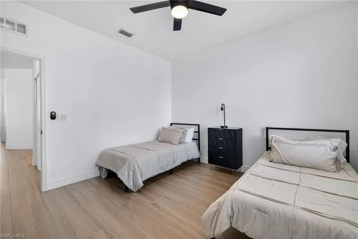 Bedroom with light wood finished floors and a ceiling fan