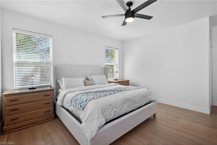Bedroom with light wood finished floors and ceiling fan