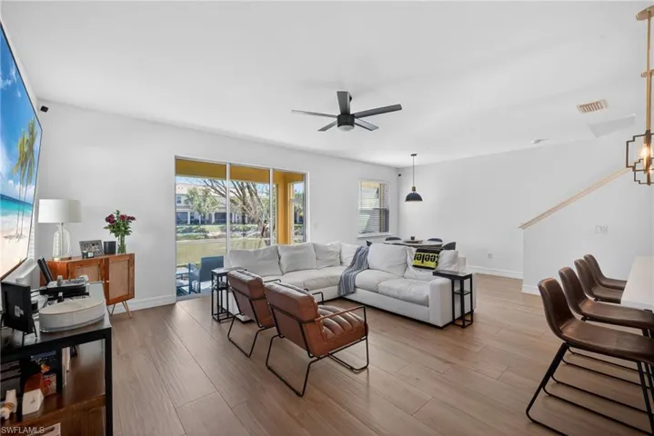Living room featuring ceiling fan and wood finished floors