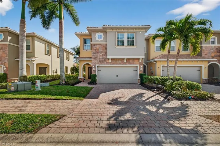 Mediterranean / spanish-style house featuring stone siding, decorative driveway, stucco siding, and an attached garage