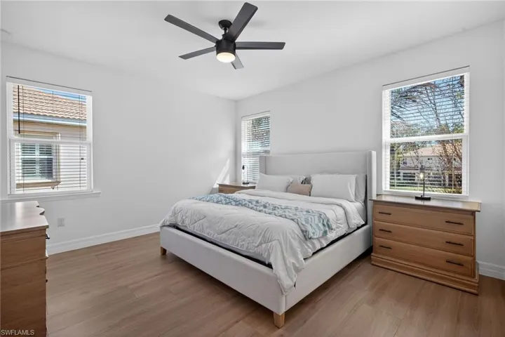 Bedroom with light wood finished floors and a ceiling fan