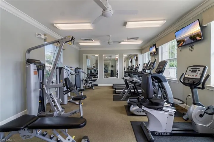 Exercise room with ceiling fan and crown molding