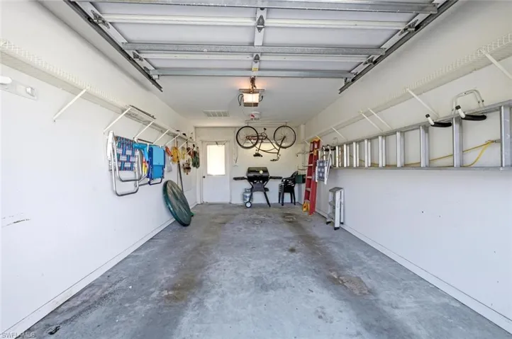 Interior with a grill, bicycle, and ladders