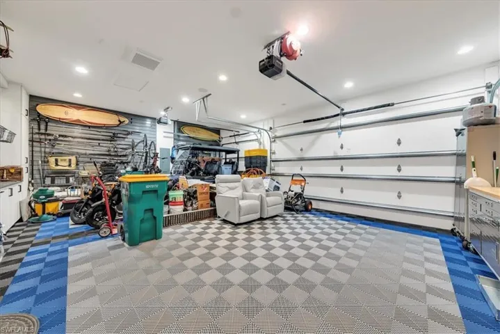Garage with recessed lighting and a garage door opener