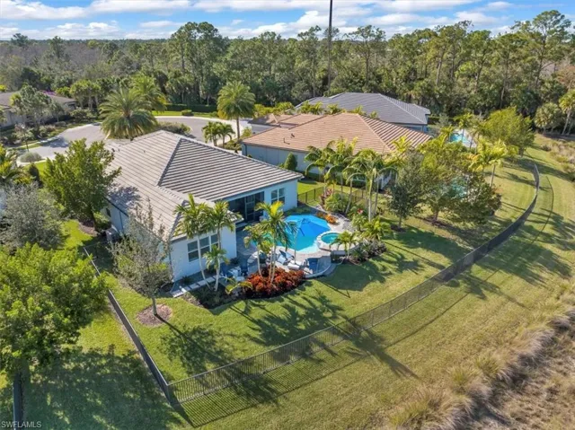 Aerial view of property and surrounding area featuring a pool