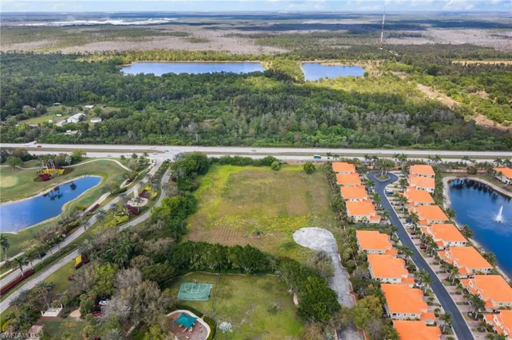Drone / aerial view with a forest view and a water view