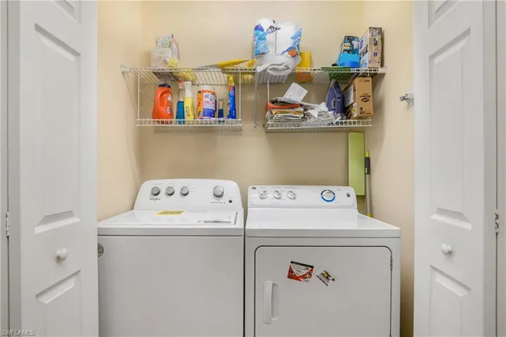 Laundry room with additional shelving.