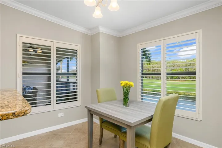 Enjoy your morning breakfast in this breakfast cafe overlooking the beautiful views. Note the plantation shutters and crown molding, both nice upgrades in this unit.
