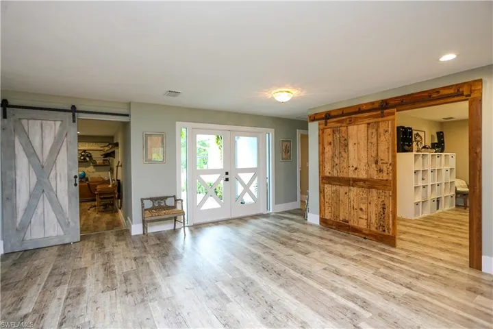 Empty room featuring a barn door and wood finished floors