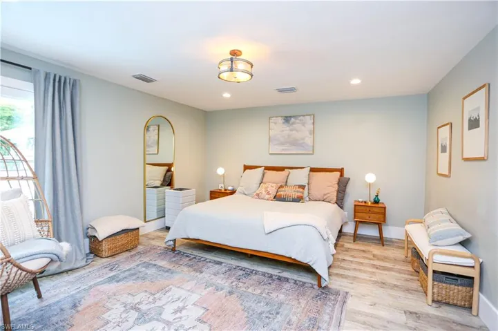 Bedroom with light wood-style flooring and recessed lighting