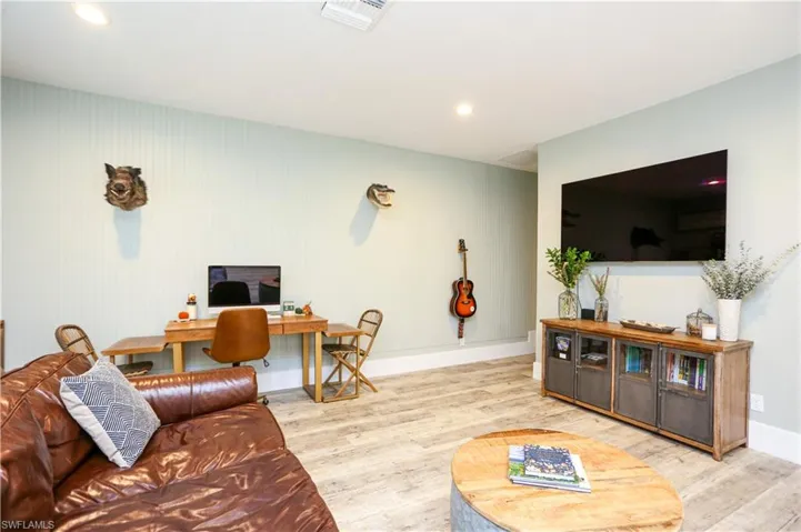 Living room featuring an office area, wood finished floors, and recessed lighting