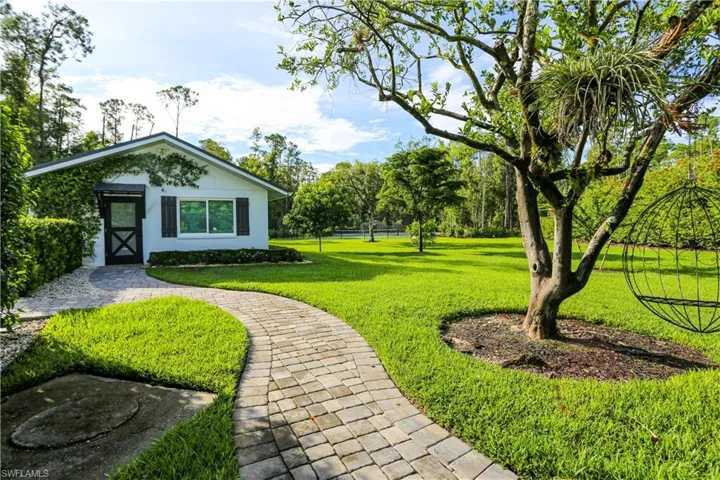 View of home's community with a yard