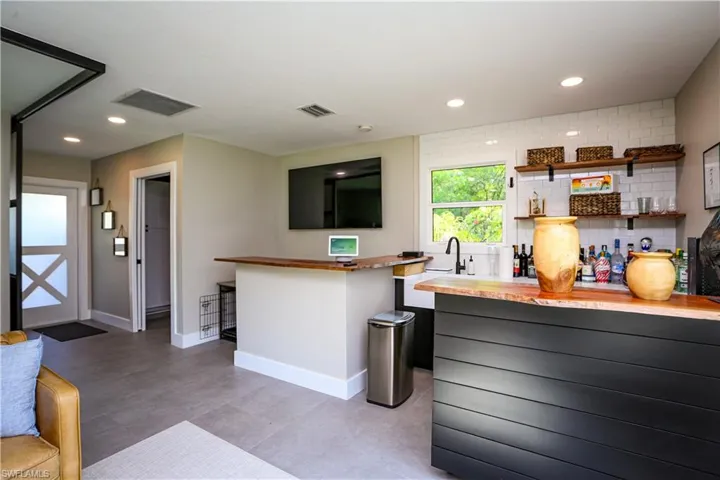 Kitchen featuring recessed lighting, backsplash, and light tile patterned floors