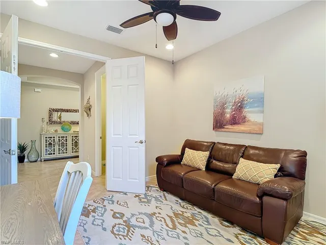 Den featuring ceiling fan