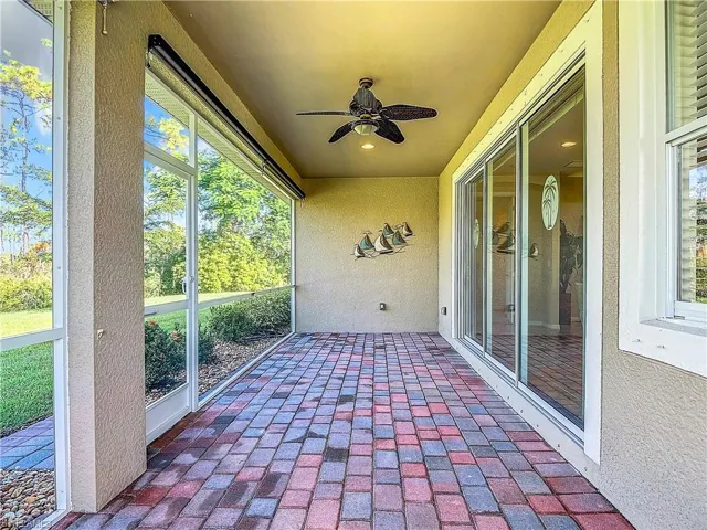 Unfurnished sunroom with ceiling fan