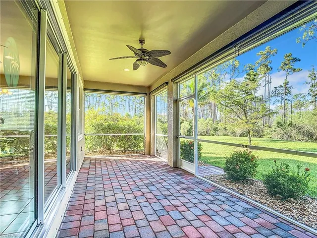 Unfurnished sunroom featuring ceiling fan