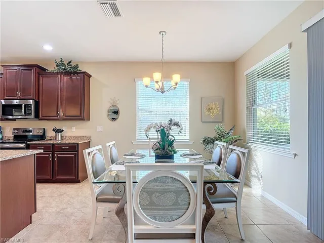 Tiled dining area with a notable chandelier