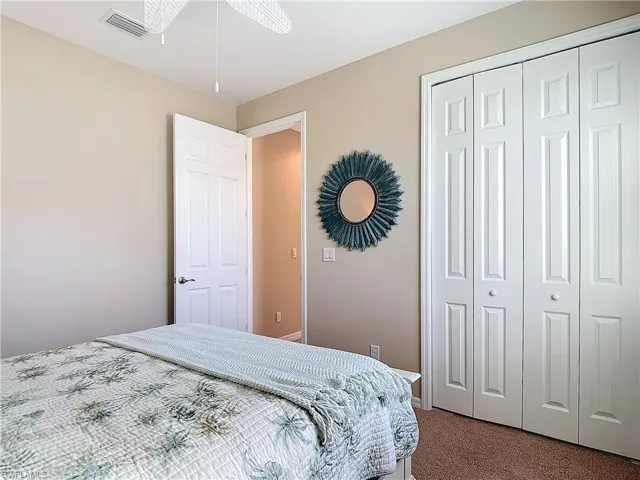 Bedroom 3 ceiling fan and a closet