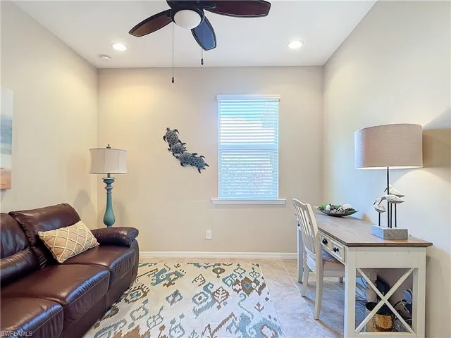 Office area with ceiling fan and light tile patterned floors