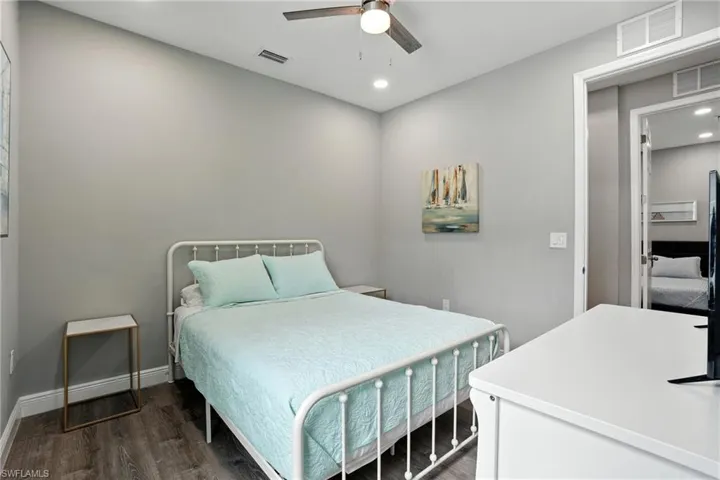 Bedroom with recessed lighting, dark wood finished floors, and a ceiling fan