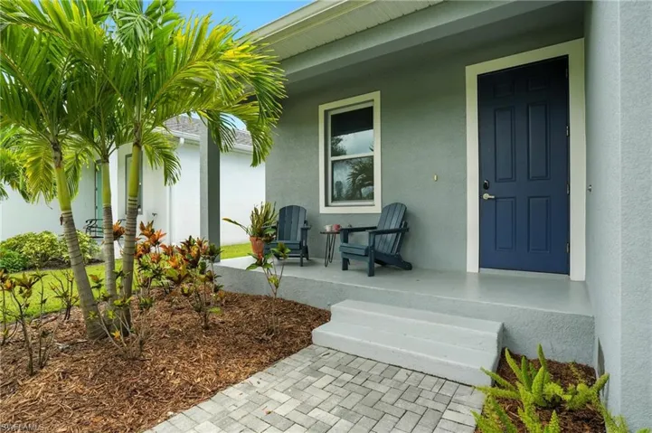 Property entrance with stucco siding and covered porch