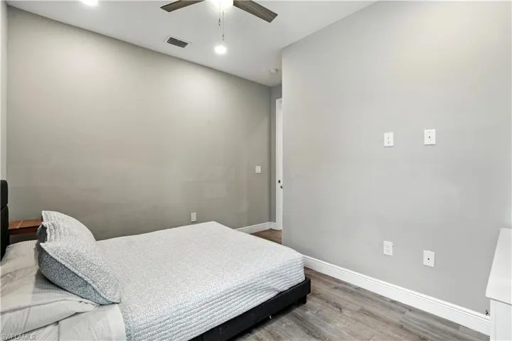 Bedroom featuring wood finished floors, ceiling fan, and recessed lighting