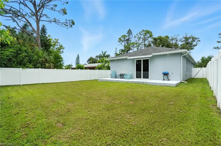 Back of property with a fenced backyard, a patio area, stucco siding, and a shingled roof