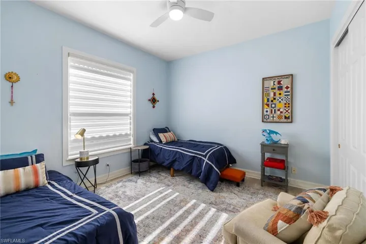 Bedroom featuring ceiling fan, a closet, and light hardwood / wood-style flooring