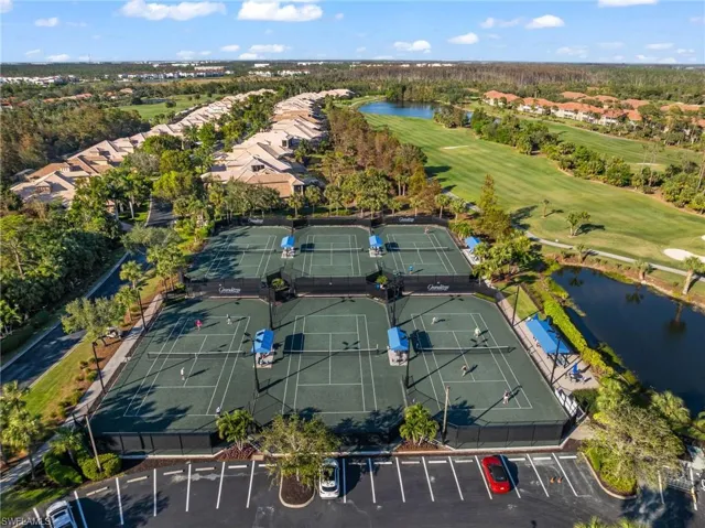 Birds eye view of property with a water view