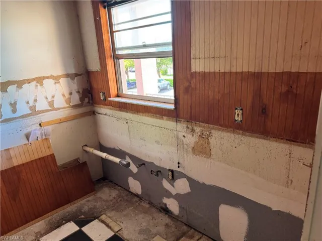 Bathroom featuring wood walls and wainscoting