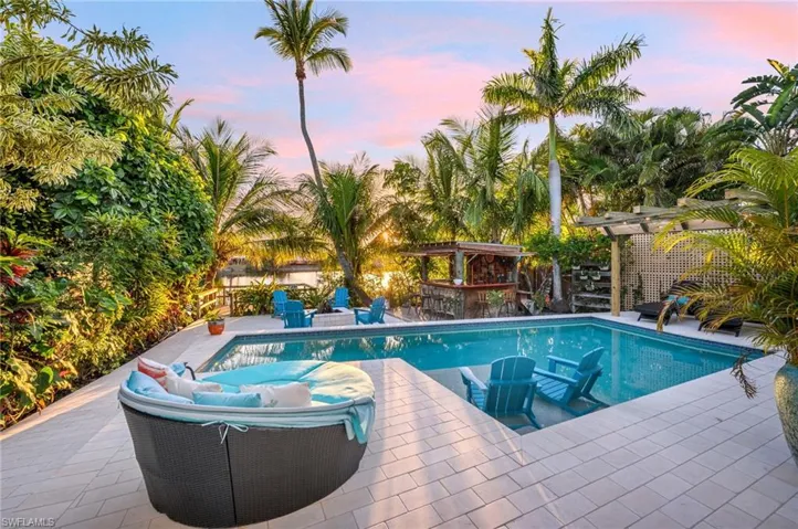Outdoor pool featuring a patio area and a bar