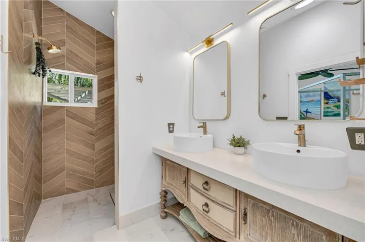Full bath with a walk in shower and double vanity