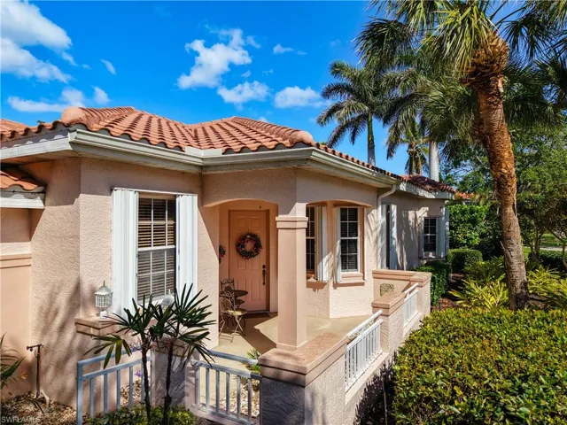 Entrance to property with covered porch, stucco siding, and a tiled roof