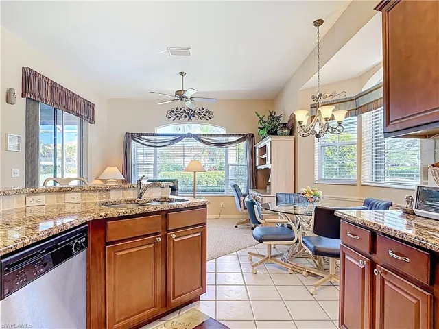 Kitchen with plenty of natural light, dishwasher, and a sink