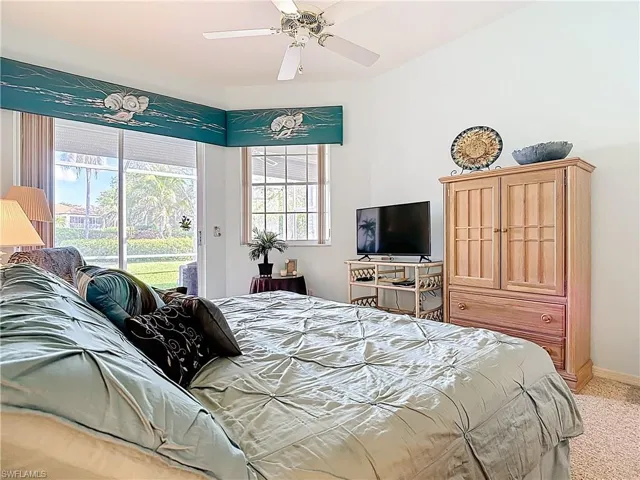 Bedroom featuring access to exterior, baseboards, light carpet, and ceiling fan