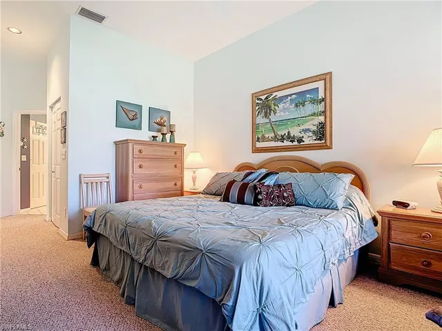 Bedroom featuring baseboards, visible vents, and light carpet