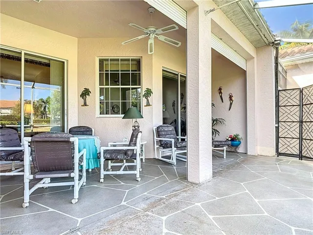 View of patio featuring a lanai and ceiling fan