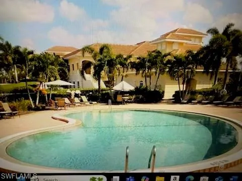Community pool with a patio