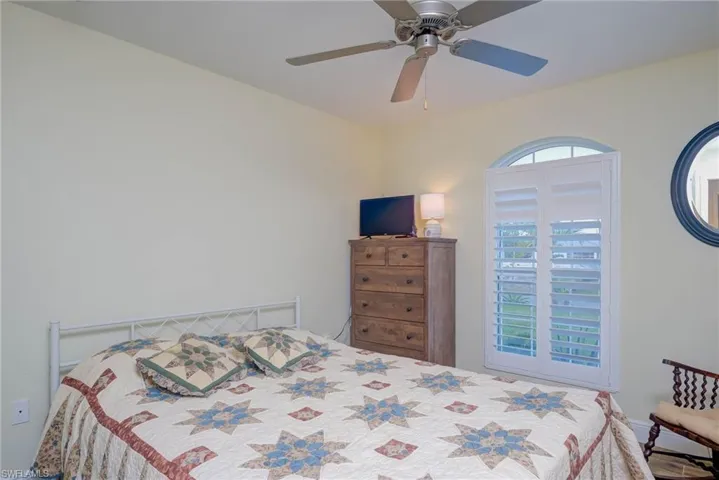 Bedroom with multiple windows and ceiling fan