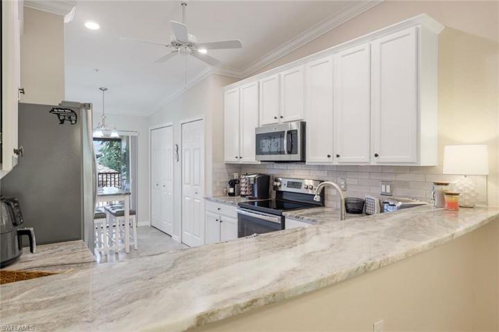 White Cabinets in Kitchen. New Counter and Backsplash