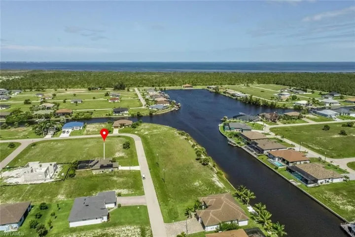 Expansive developable lot featuring direct canal access and a partially constructed residence