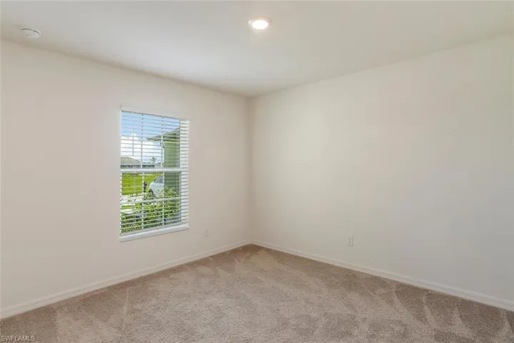 Neutral-toned walls and plush carpeting provide a versatile foundation