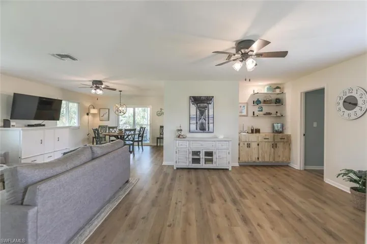Living room featuring ceiling fan and wood-type flooring