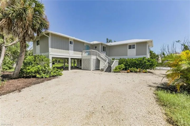 View of front facade with a porch and a carport
