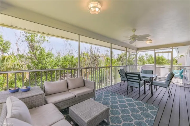 Sunroom / solarium featuring a healthy amount of sunlight and ceiling fan
